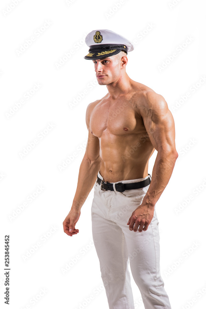 Muscular shirtless male sailor with navy hat, isolated on white