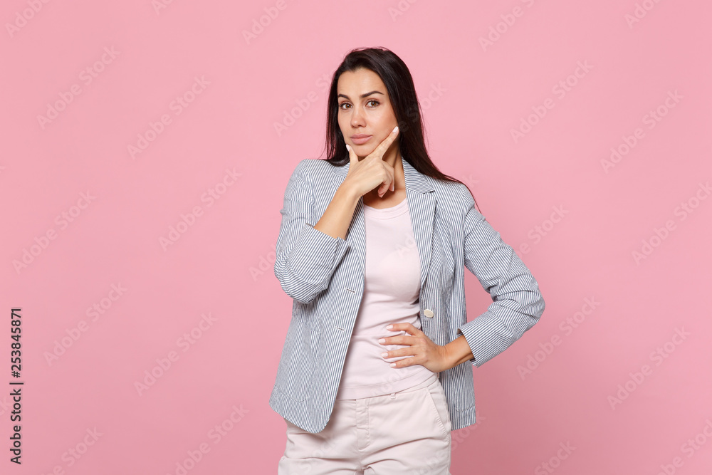 Portrait of confident young woman in striped jacket looking camera and put hand prop up on chin isolated on pink pastel wall background. People sincere emotions, lifestyle concept. Mock up copy space. Portrait of confident young woman in striped jacket looking camera and put hand prop up on chin isolated on pink pastel wall background. People sincere emotions, lifestyle concept. Mock up copy space.