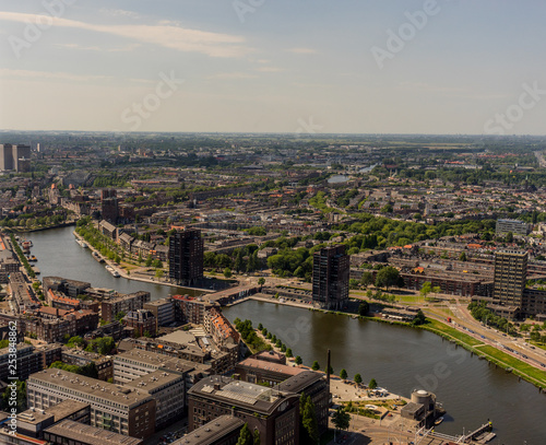 Netherlands, Rotterdam, a view of a city next to a body of water © SkandaRamana