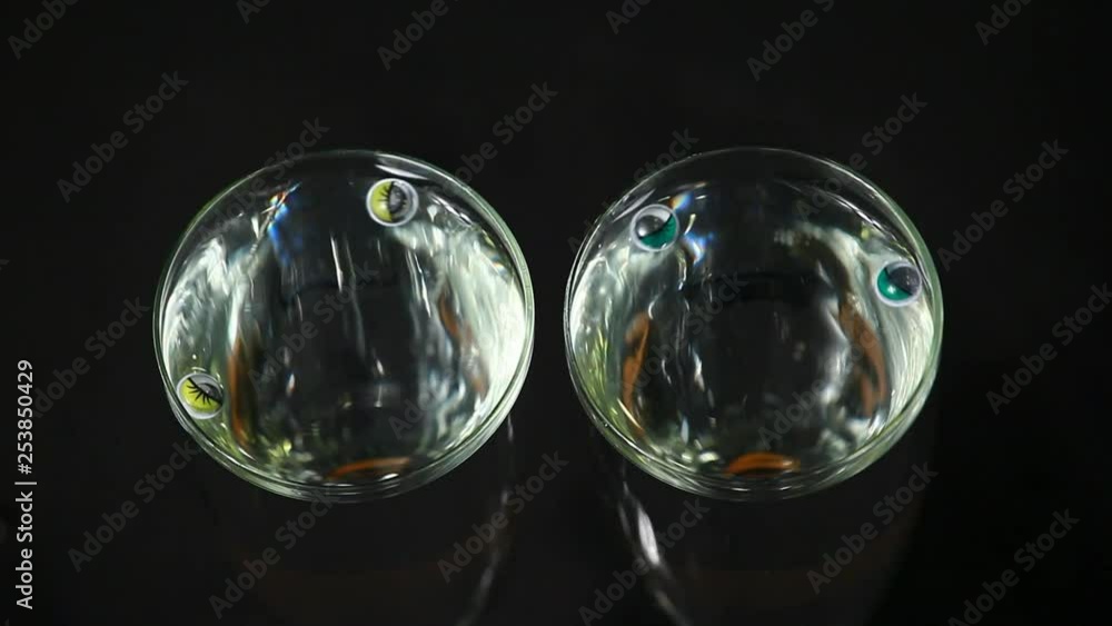 plastic eyes champagne glass water dark background nobody hd footage 