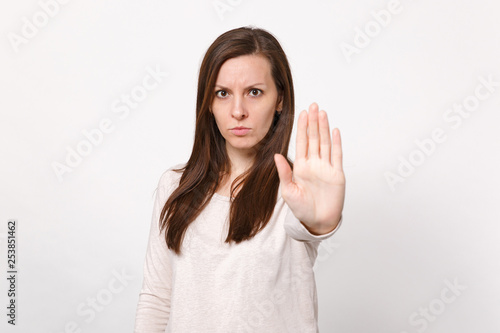 Wallpaper Mural Portrait of serious concerned young woman in light clothes showing stop gesture with palm isolated on white wall background in studio. People sincere emotions, lifestyle concept. Mock up copy space. Torontodigital.ca