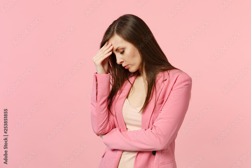 Portrait of tired young woman wearing jacket putting hand on lowered head, keeping eyes closed isolated on pastel pink wall background. People sincere emotions, lifestyle concept. Mock up copy space. Portrait of tired young woman wearing jacket putting hand on lowered head, keeping eyes closed isolated on pastel pink wall background. People sincere emotions, lifestyle concept. Mock up copy space.