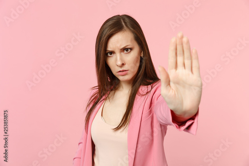Wallpaper Mural Portrait of disconcerted young woman in jacket looking camera, showing stop gesture with palm isolated on pastel pink wall background. People sincere emotions, lifestyle concept. Mock up copy space. Torontodigital.ca