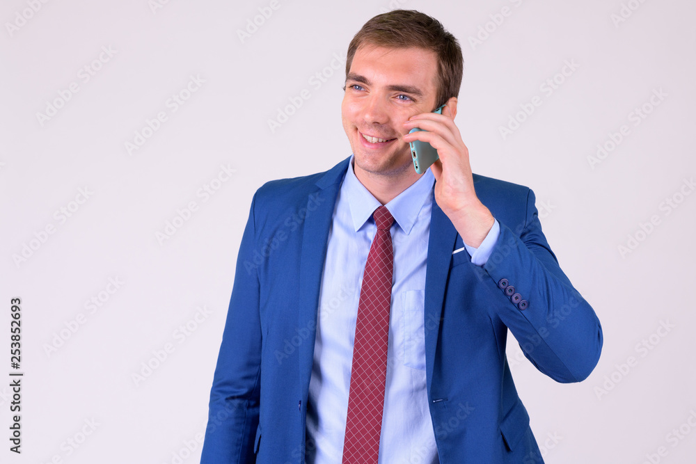 Portrait of happy businessman in suit talking on the phone Portrait of happy businessman in suit talking on the phone