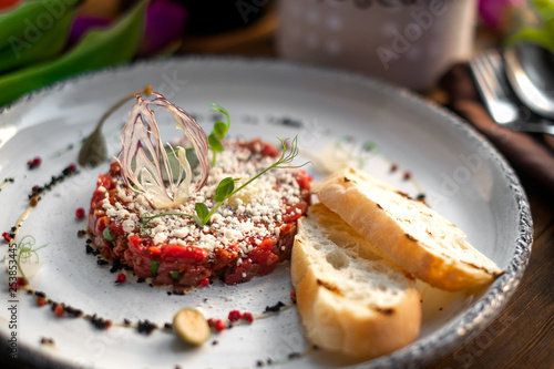 Beef Tartar with croutons on white plate, molecular Haute cuisine