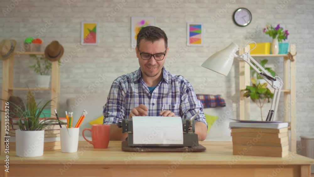 Man writer works at home throwing sheets of paper and enthusiastically typing on an old typewriter. Man writer works at home throwing sheets of paper and enthusiastically typing on an old typewriter.