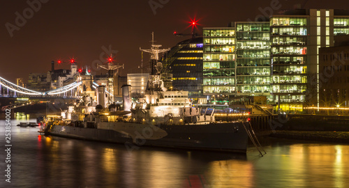 The HMS Belfast at night along the river Thames © Dolwolfian
