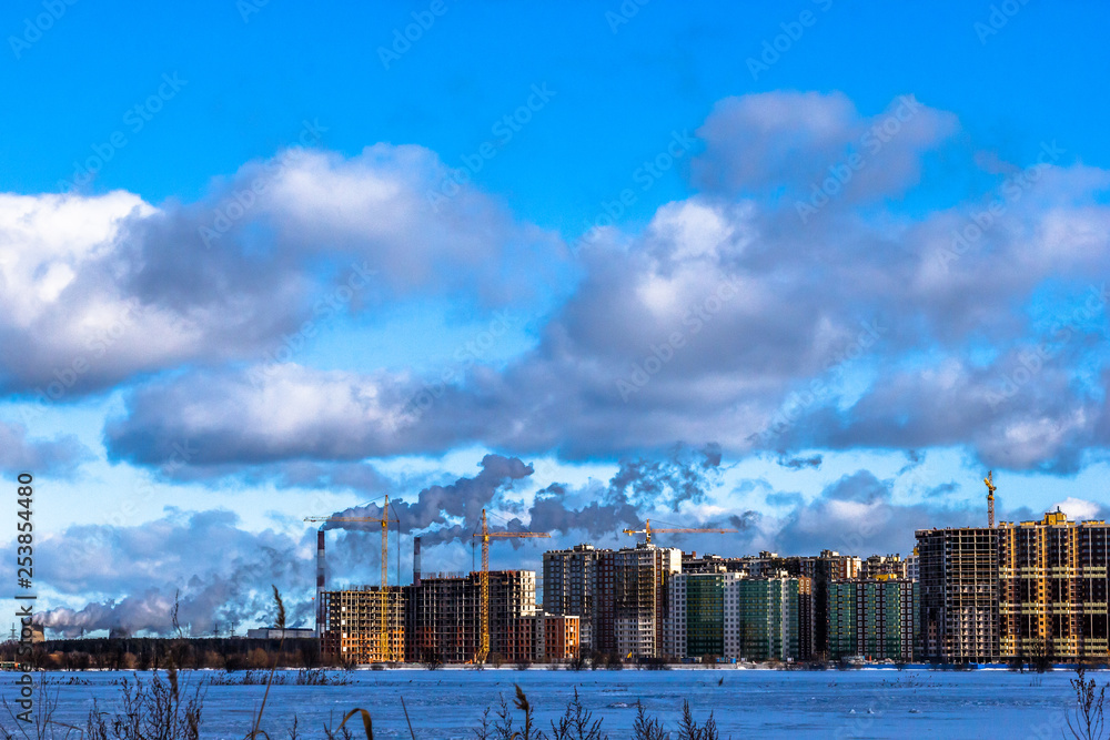 Construction of multi-storey residential buildings in the big city. Winter city landscape