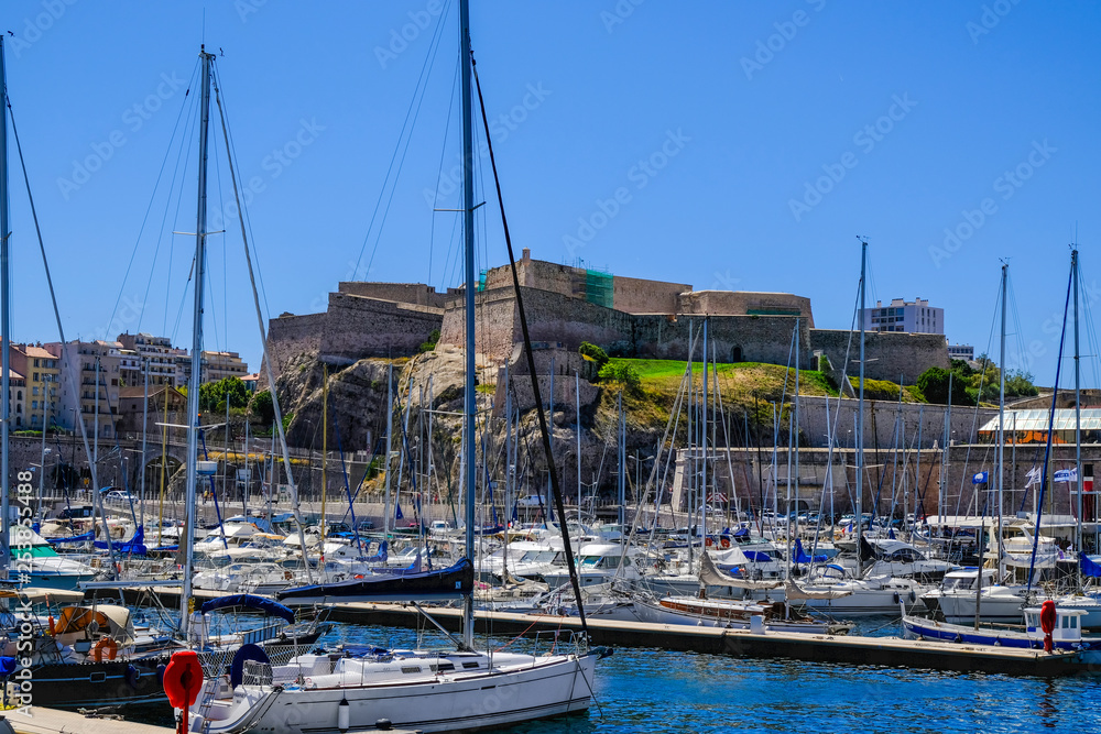 MARSEILLE, FRANCE - AUGUST 11, 2018 - Marseille embankment with yachts and boats in the Old Port and Fort Saint-Nicolas. Vieux-Port de Marseille.