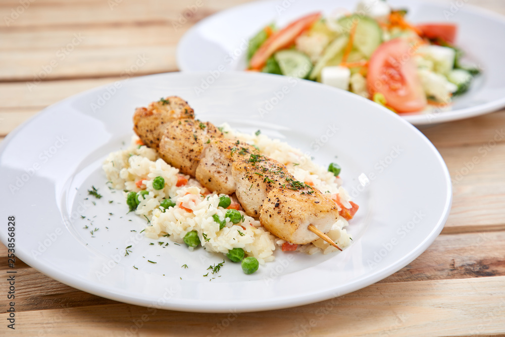 chicken kebab with rice and salad on the wooden background chicken kebab with rice and salad on the wooden background