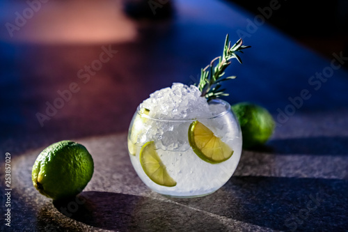 The bartender prepares a cocktail Cassis Caipirinha (Caipirissima, Caipiroska). Pours liquor on ice frappe.. photo