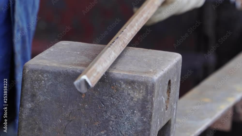 Blacksmith hammering metal on the anvil close-up Blacksmith hammering metal on the anvil close-up