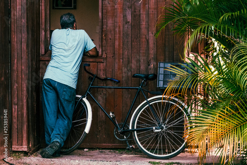 Photography man and bicycle in front of old house