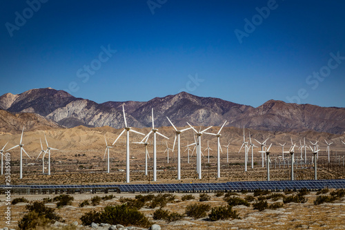 wind turbines and solar panels in the desert