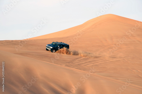 Desert safari on sand dunes on the off-road cars