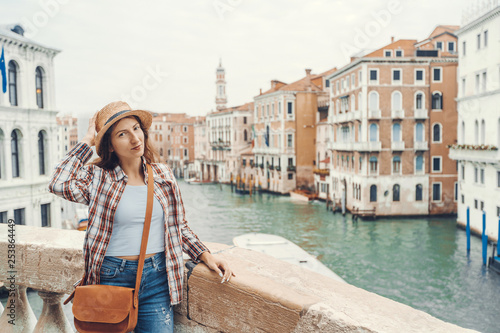 Woman in the Venice, standing on the bridge over the grand canal while on sightseeing in a foreign city. Discovery the Venice adventure. © Sokirlov