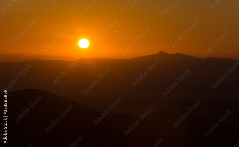Amazing sunrise above mountain ridge with hill 