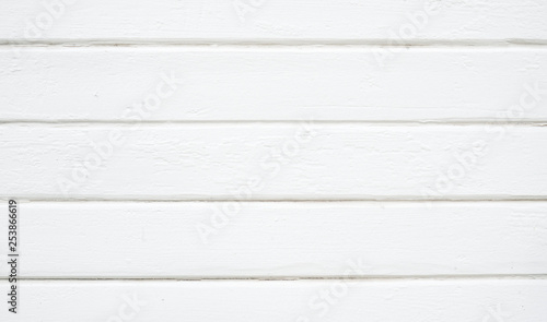 Rustic painted wood wall or siding. Peeling white paint with light neutral flat faded tones.