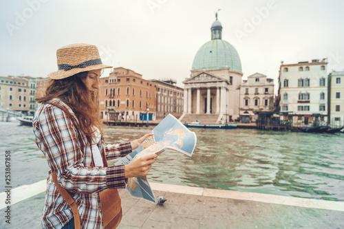 Discovery the Venice. Traveler girl looks at the map of walking, female adventure in Venice, Chiesa di San Simeone Piccolo, Italy