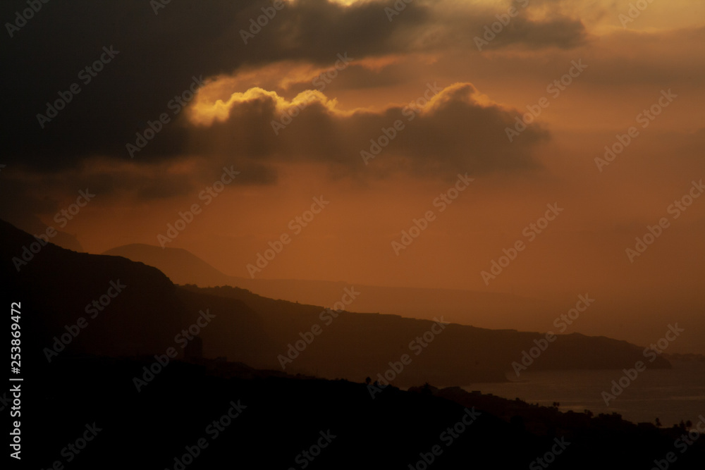 colorful sunset over tenerife behind clouds