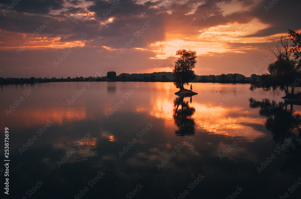 Summer lake with tree and alone man Summer lake with tree and alone man