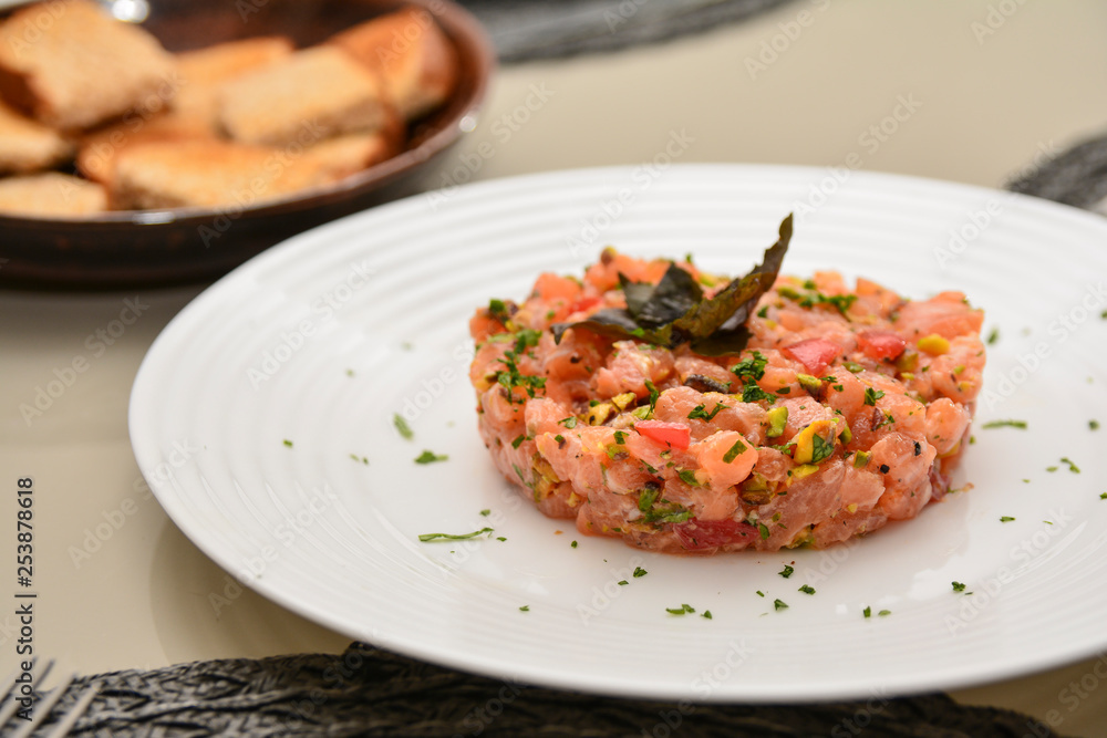 Fresh Salmon Tartar with pistachio, basil and herbs Fresh Salmon Tartar with pistachio, basil and herbs