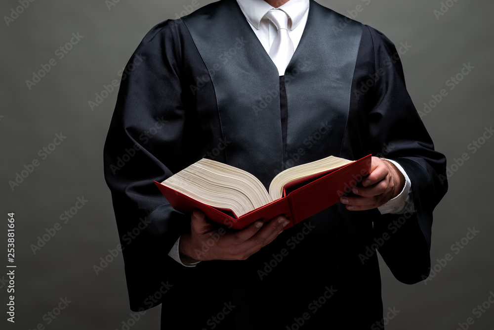 Rechtsanwalt mit Robe und Gesetzbuch Stock Photo | Adobe Stock