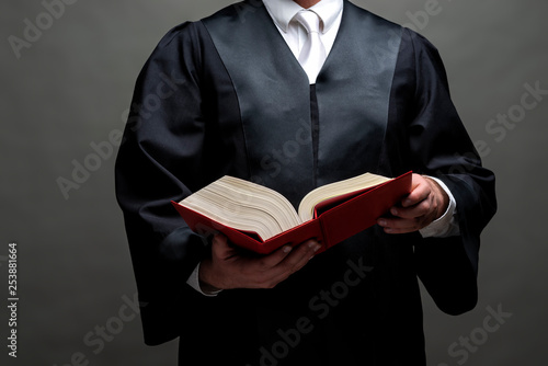 Rechtsanwalt mit Robe und Gesetzbuch photo