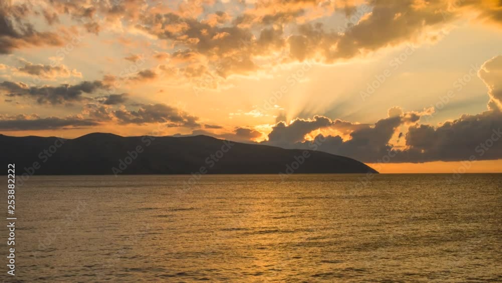 Sunset timelapse with fast moving clouds and godrays at the coast of Vlora, Albania. Sunset timelapse with fast moving clouds and godrays at the coast of Vlora, Albania.