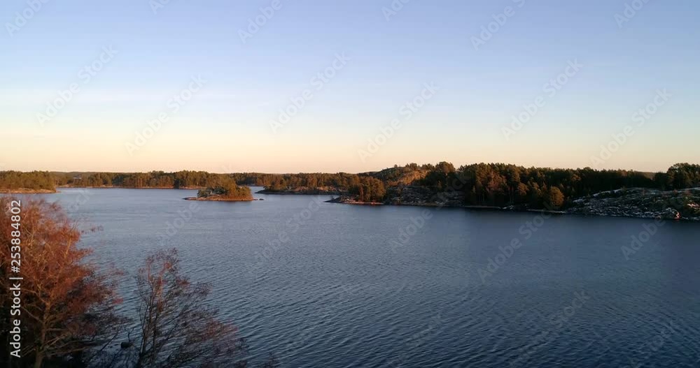 Aerial, rising, drone shot, of the baltic sea, the autumn archipelago and snowy islands, on the gulf of Finland, at sunset, on a sunny, cold, fall evening, in Uusimaa, Finland Aerial, rising, drone shot, of the baltic sea, the autumn archipelago and snowy islands, on the gulf of Finland, at sunset, on a sunny, cold, fall evening, in Uusimaa, Finland