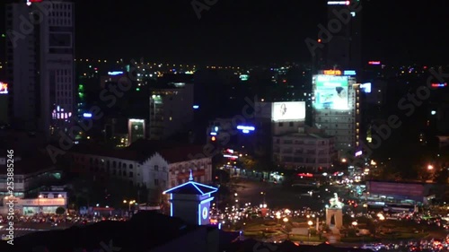 Saigon traffic by night.Crowded streets with an unusual  flow of never ending moped traffic. photo