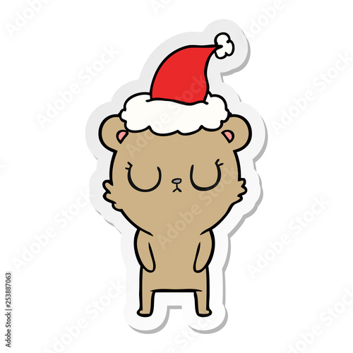 peaceful sticker cartoon of a bear wearing santa hat © lineartestpilot