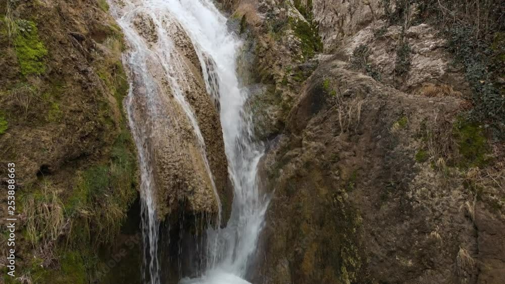 Close drone shot of small waterfall Close drone shot of small waterfall