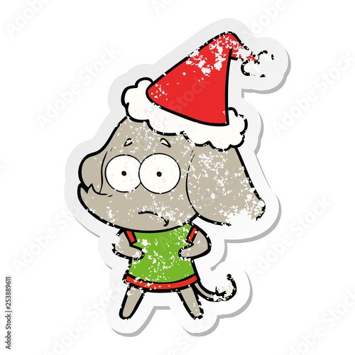 distressed sticker cartoon of a unsure elephant wearing santa hat