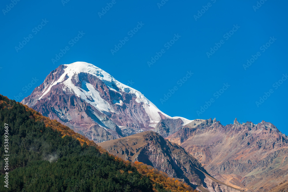 Mount Kazbek (Mkinvartsveri) at sunny day. Caucasus mountains