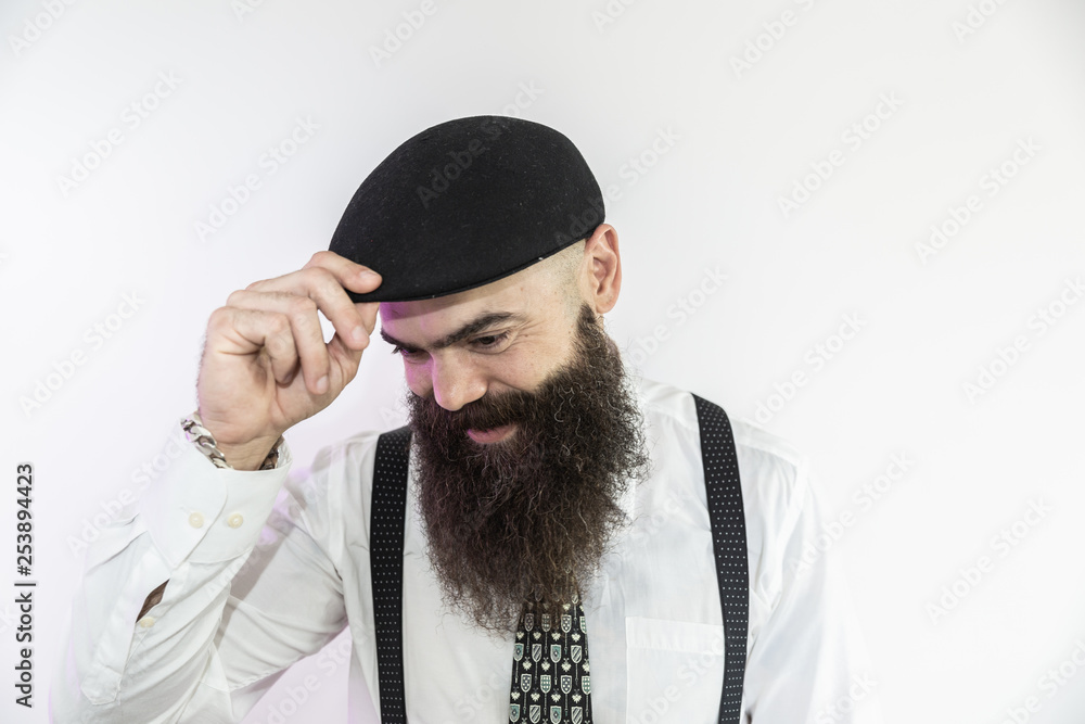 Bearded man looking down. Concept of masculinity and care with the beard. Pointing with finger, approving or indicating. Bearded man looking down. Concept of masculinity and care with the beard. Pointing with finger, approving or indicating.