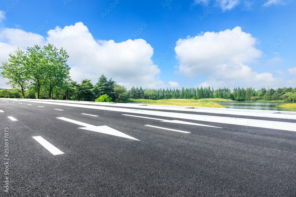 Fototapeta premium Asphalt road and green forest landscape in summer season