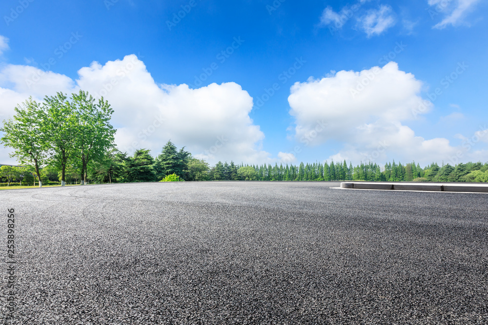 Empty asphalt pavement and green forest landscape in summer season