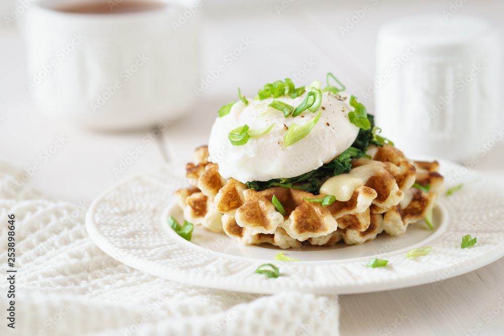 Waffles with poached egg, cheese and spinach.