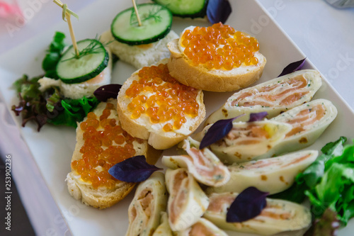 Delicious toasts with red caviar on the holiday table.