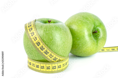 green apples with Measuring tape on white background