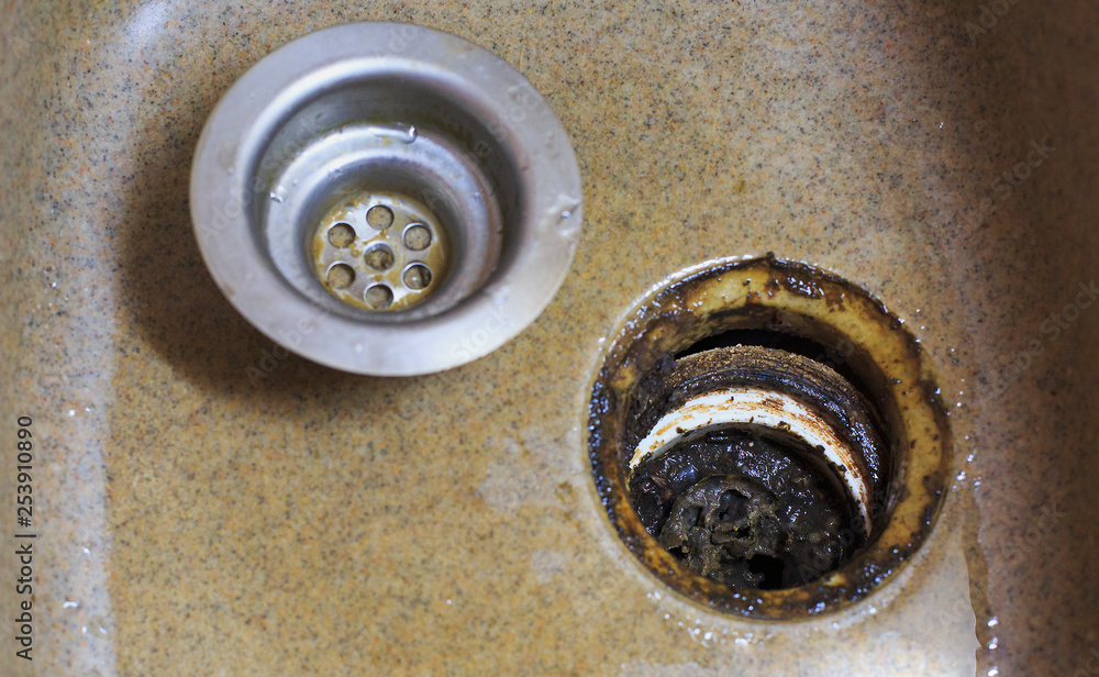 Clogged kitchen sink in the kitchen. Cleaning a clogged, dirty washbasin Clogged kitchen sink in the kitchen. Cleaning a clogged, dirty washbasin