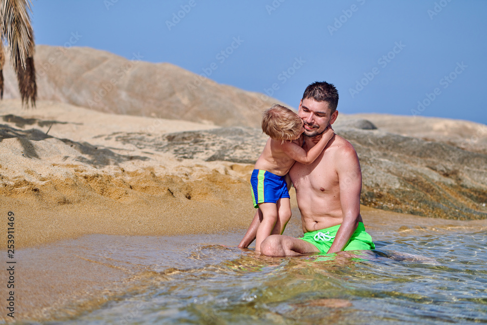 Fototapeta premium Toddler boy on beach with father
