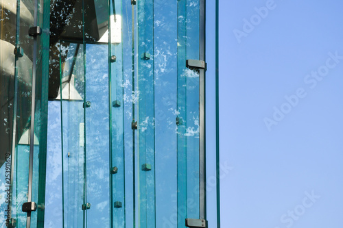 Frameless glass facade modern building, tempered laminated glass wall or curtain wall blue color, Modern architecture material