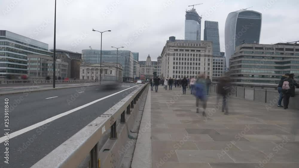 Time lapse. A view of a road at a busy time with people and vehicles passing by. Time lapse. A view of a road at a busy time with people and vehicles passing by.