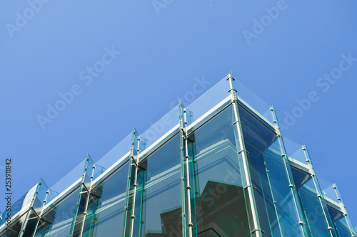 Frameless glass facade modern building, tempered laminated glass wall or curtain wall blue color, Modern architecture material