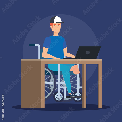 disabled man sitting wheelchair and working with laptop