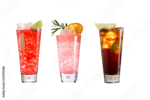 A variety of alcoholic drinks, beverages and cocktails on a white background. Three refreshing drinks in glass goblets.