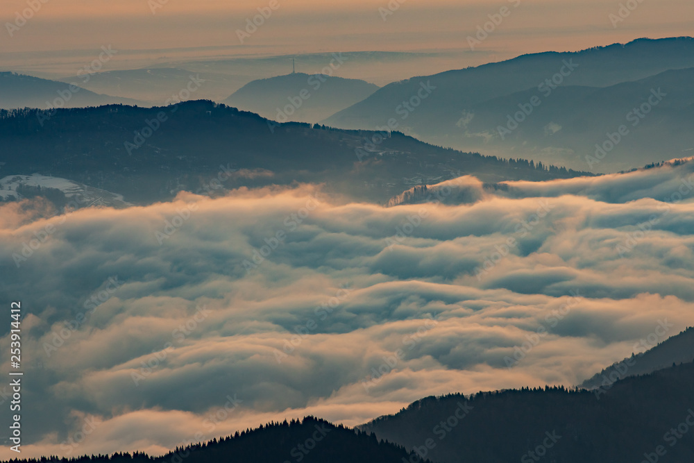 Mountain landscape with winter fog at sunse of Ceahlau, Romaniat