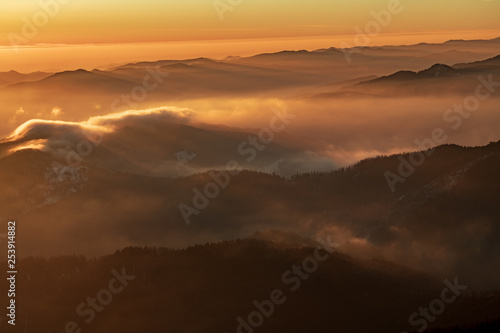 Mountain landscape with winter fog at sunse of Ceahlau, Romaniat © brszattila